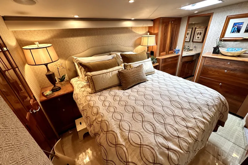 Reel Inn Yacht Photos Pics Luxurious bedroom interior of 2003 Viking 61 Convertible yacht with elegant decor and lighting.
