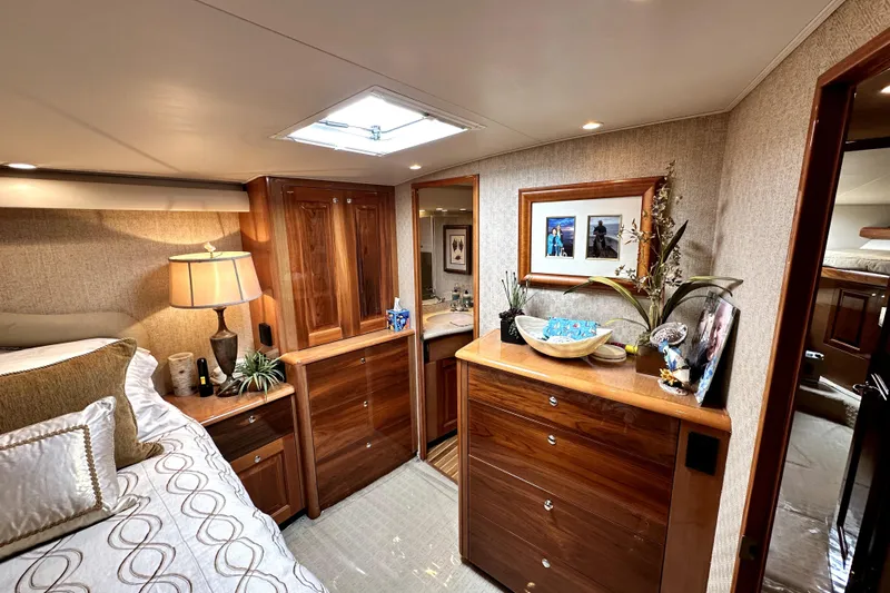 Reel Inn Yacht Photos Pics Luxurious bedroom interior of 2003 Viking 61 Convertible yacht with elegant wood furnishings.