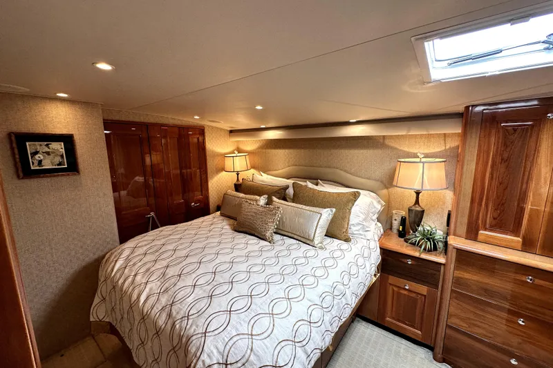 Reel Inn Yacht Photos Pics Luxurious bedroom interior of 2003 Viking 61 Convertible yacht with elegant wood finishes.