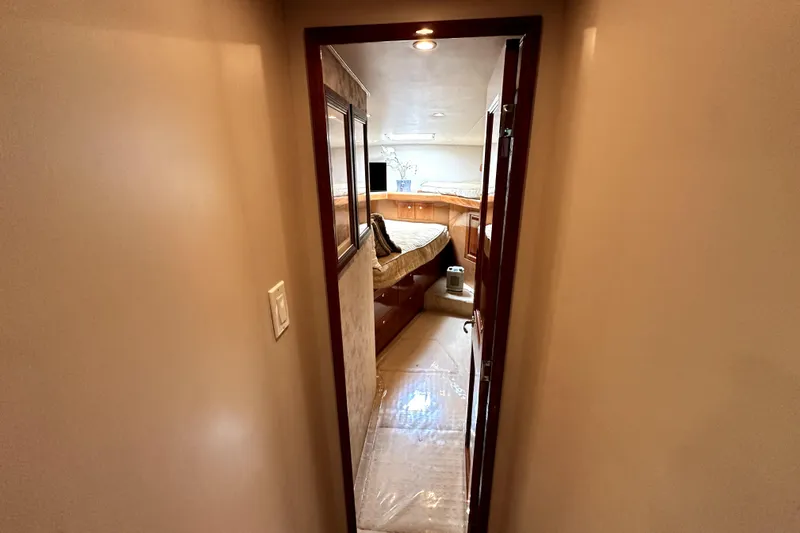 Reel Inn Yacht Photos Pics Interior view of 2003 Viking 61 Convertible yacht cabin with cozy bed and wooden furnishings.