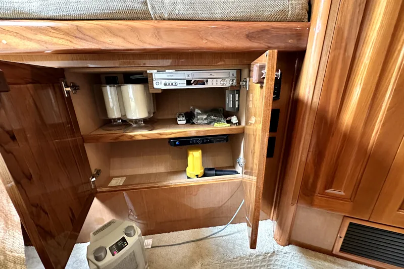 Reel Inn Yacht Photos Pics Open cabinet in 2003 Viking 61 Convertible yacht with electronic equipment and storage.