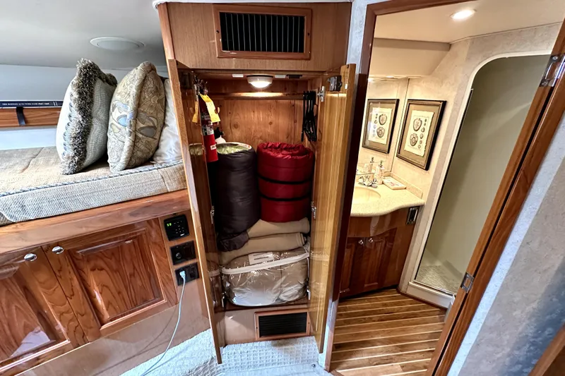 Reel Inn Yacht Photos Pics 2003 Viking 61 Convertible interior with storage, pillows, and bathroom view.