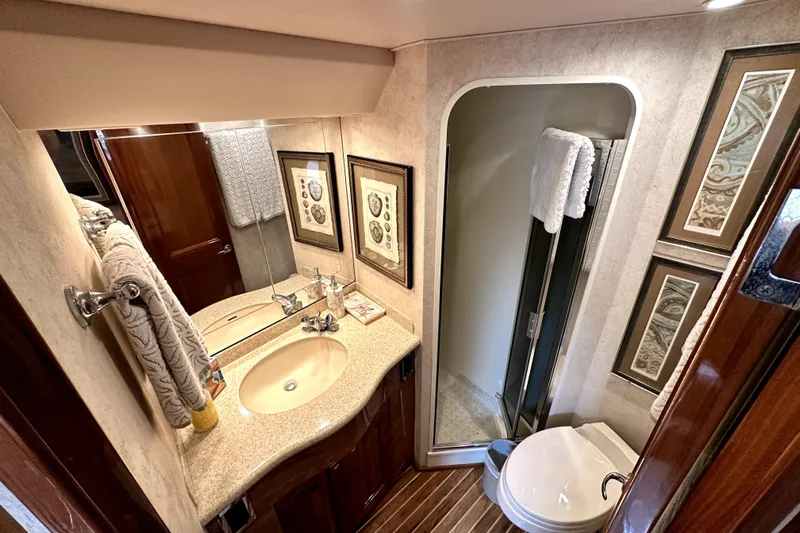 Reel Inn Yacht Photos Pics Luxurious bathroom in 2003 Viking 61 Convertible yacht with elegant fixtures and decor.