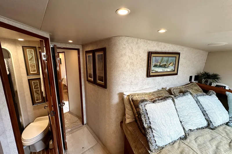 Reel Inn Yacht Photos Pics Interior of 2003 Viking 61 Convertible yacht with cozy bedroom and bathroom.