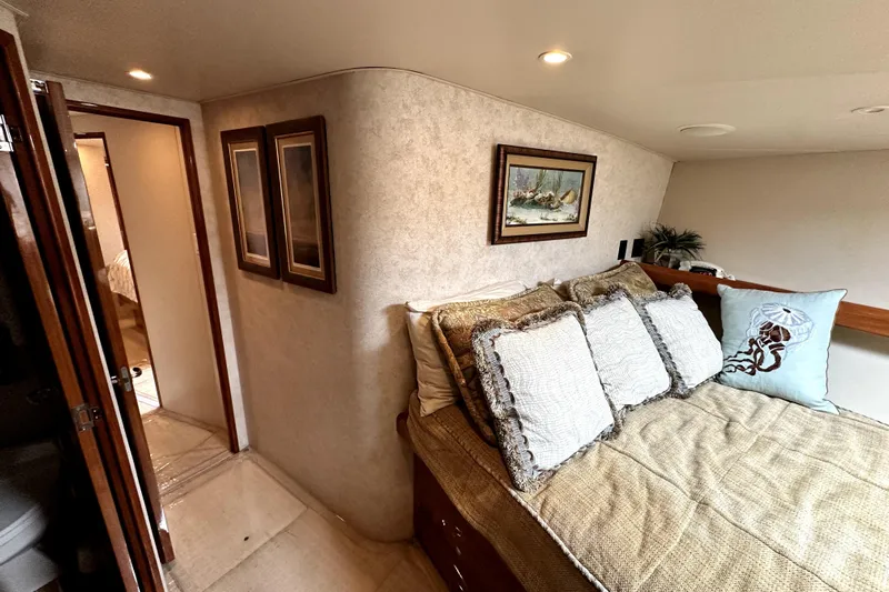 Reel Inn Yacht Photos Pics Cozy bedroom in 2003 Viking 61 Convertible yacht with elegant decor and soft lighting.