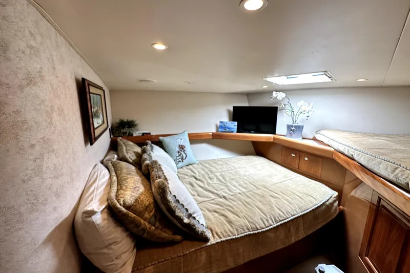 Reel Inn Yacht Photos Pics Luxurious bedroom interior of 2003 Viking 61 Convertible yacht with cozy bedding and decor.