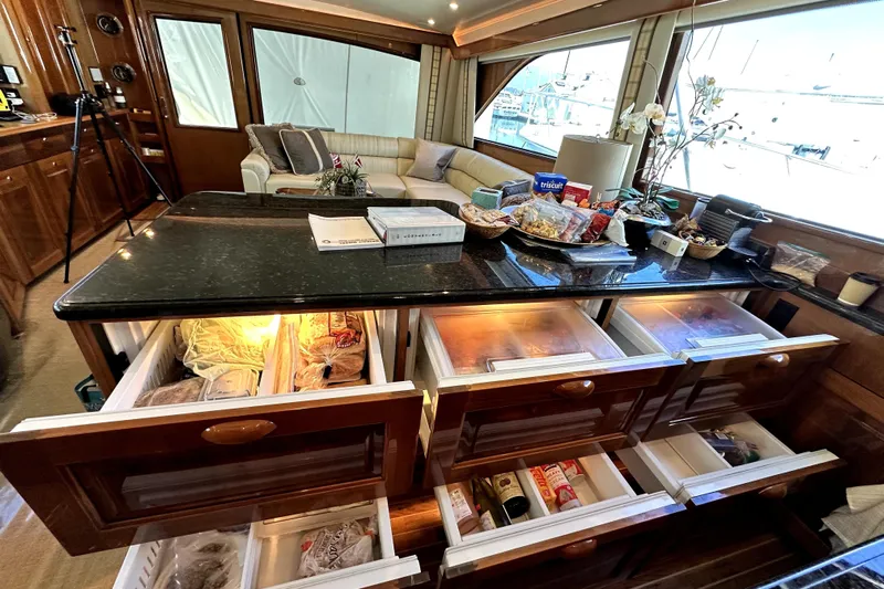 Reel Inn Yacht Photos Pics Luxurious 2003 Viking 61 Convertible yacht interior with open kitchen reefers and freezers and elegant seating area.