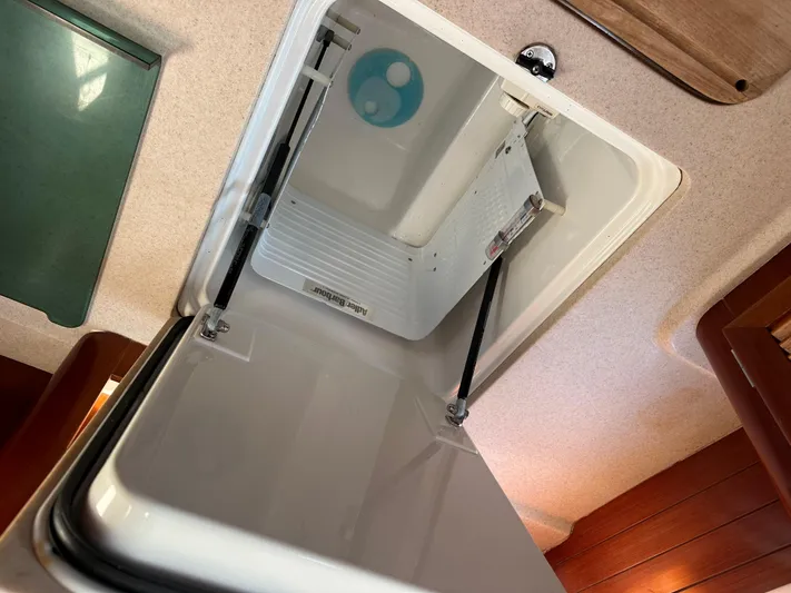 Pono Yacht Photos Pics Open hatch inside 2006 Beneteau 423 sailboat, showcasing interior storage compartment.