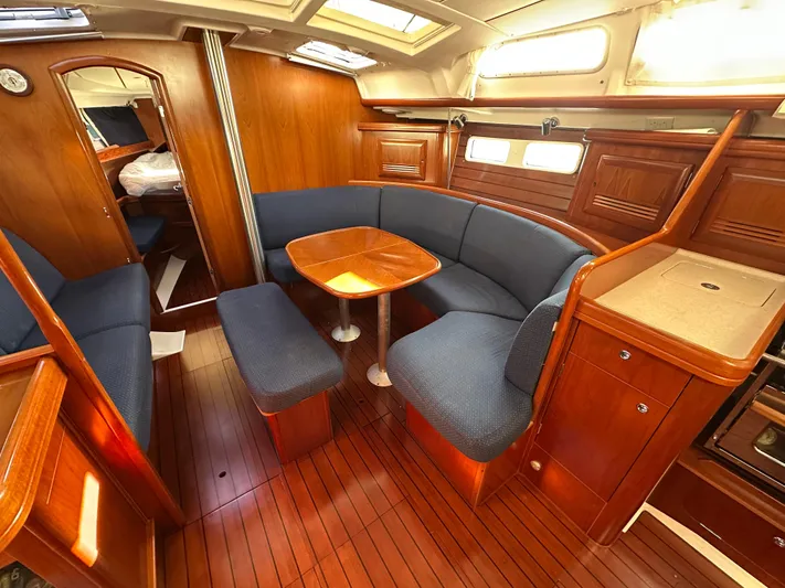 Pono Yacht Photos Pics Interior of 2006 Beneteau 423 yacht with wooden finish and blue seating.