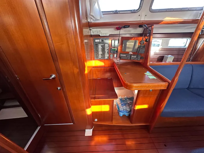 Pono Yacht Photos Pics Interior of 2006 Beneteau 423 sailboat with navigation station and wooden cabinetry.
