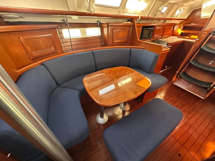 Pono Yacht Photos Pics Luxurious interior of 2006 Beneteau 423 yacht with wooden finishes and cozy seating area.