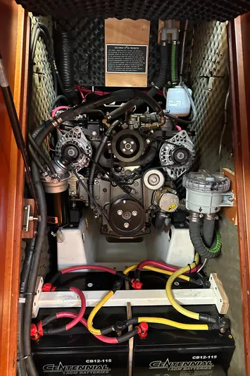 Pono Yacht Photos Pics Engine compartment of a 2006 Beneteau 423 sailboat with visible batteries and wiring.