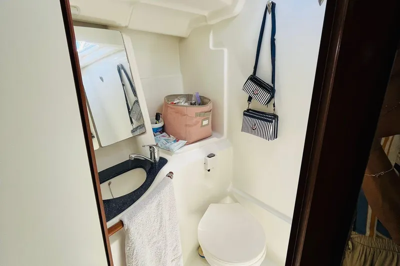  Yacht Photos Pics Bathroom interior of 2006 Beneteau 473 yacht with sink, mirror, and toilet.