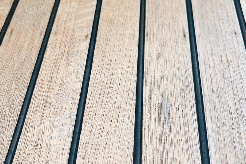  Yacht Photos Pics Teak deck of 2006 Beneteau 473 sailboat, featuring parallel grooves.