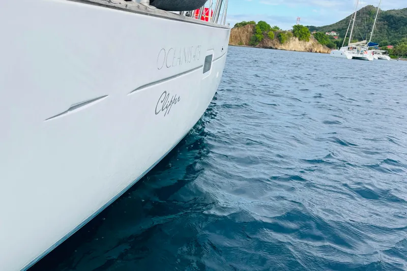  Yacht Photos Pics Beneteau 473 sailboat on water, 2006 model, near scenic coastline.