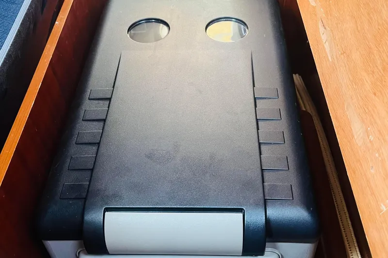  Yacht Photos Pics Storage compartment on a 2006 Beneteau 473 yacht, featuring a black cover with circular openings.