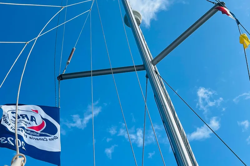 Yacht Photos Pics Sailboat mast and flags against blue sky, Beneteau 473, 2006 model.