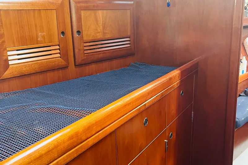  Yacht Photos Pics Interior of 2006 Beneteau 473 yacht with wooden cabinetry and storage.