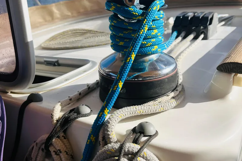  Yacht Photos Pics Close-up of sailing ropes and winch on a 2006 Beneteau 473 yacht deck.