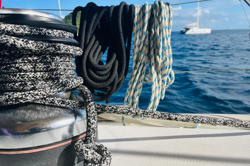  Yacht Photos Pics Close-up of ropes on a 2006 Beneteau 473 sailboat with ocean background.