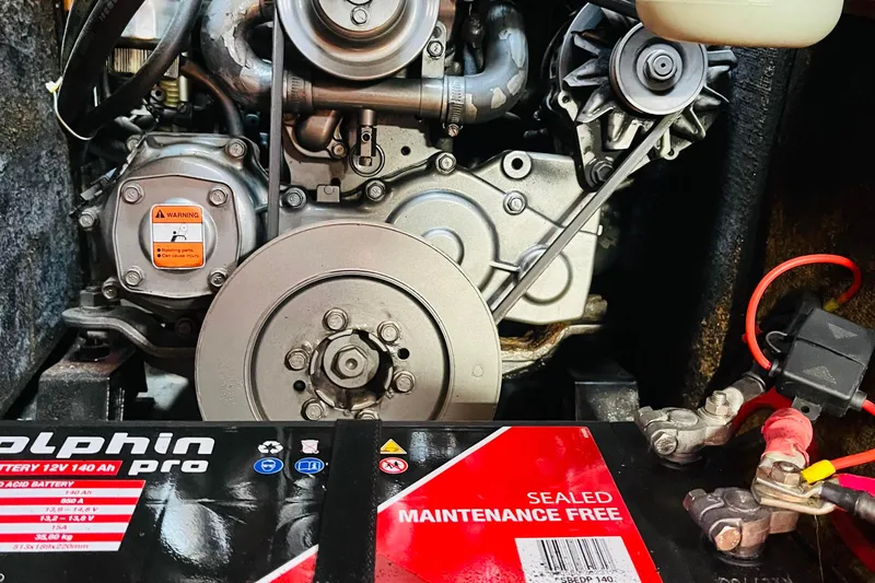  Yacht Photos Pics Engine compartment of a 2006 Beneteau 473 sailboat with visible battery and components.