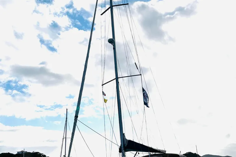  Yacht Photos Pics Sailboat mast of a 2006 Beneteau 473 against a cloudy sky.
