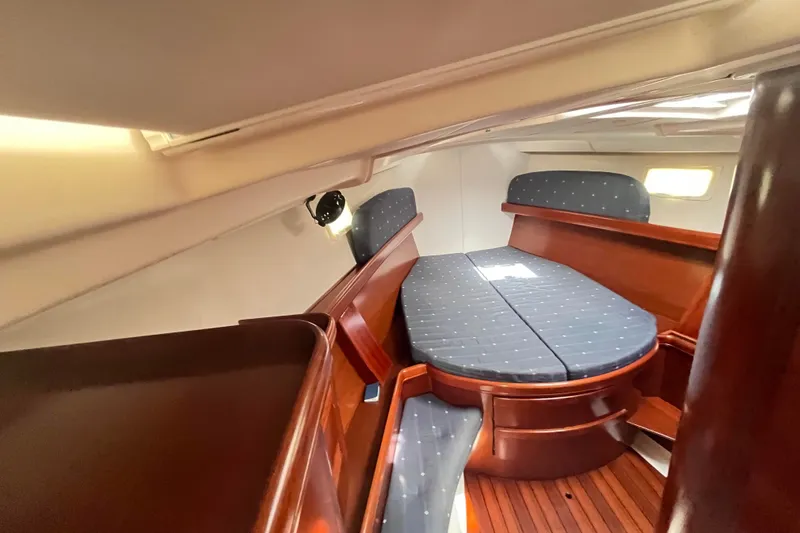  Yacht Photos Pics Luxurious cabin interior of 2006 Beneteau 473 yacht with polished wood and cozy seating.