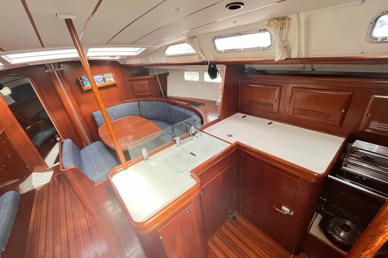  Yacht Photos Pics Luxurious interior of a 2006 Beneteau 473 yacht with wood finishes and modern amenities.