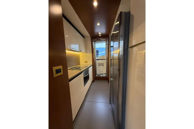  Yacht Photos Pics Modern kitchen interior on 2014 Azimut 80 yacht, featuring sleek cabinetry and appliances.