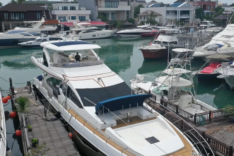  Yacht Photos Pics Luxurious 2014 Azimut 80 yacht docked in a marina with surrounding boats.