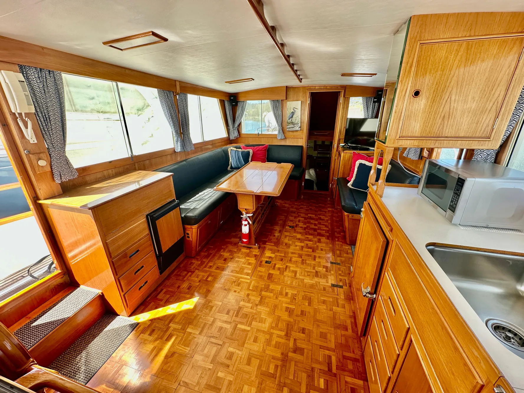 Interior of 1989 Grand Banks 42 Classic yacht with wood finish and seating area.