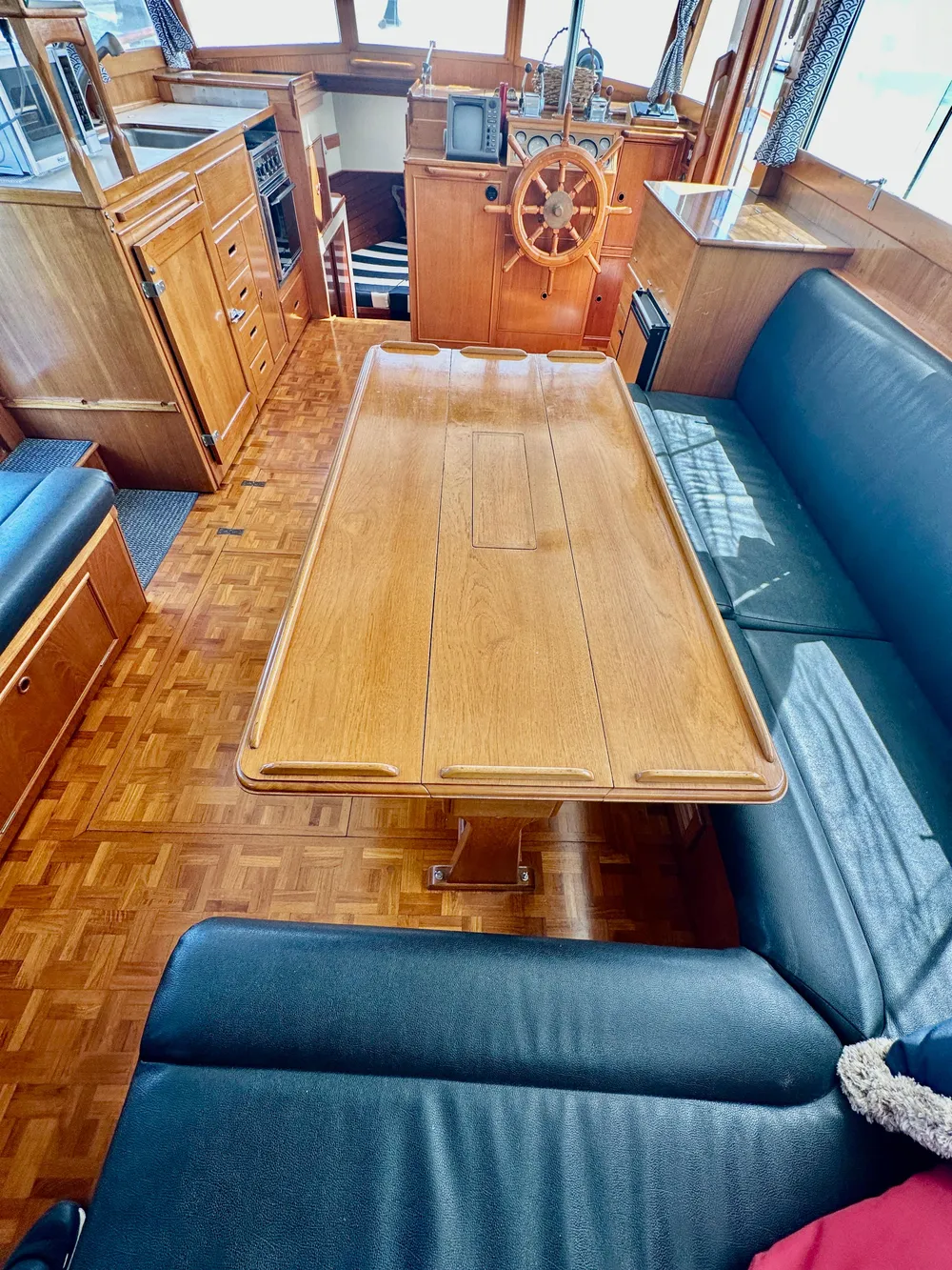 Interior of 1989 Grand Banks 42 Classic yacht with wooden table and seating area.