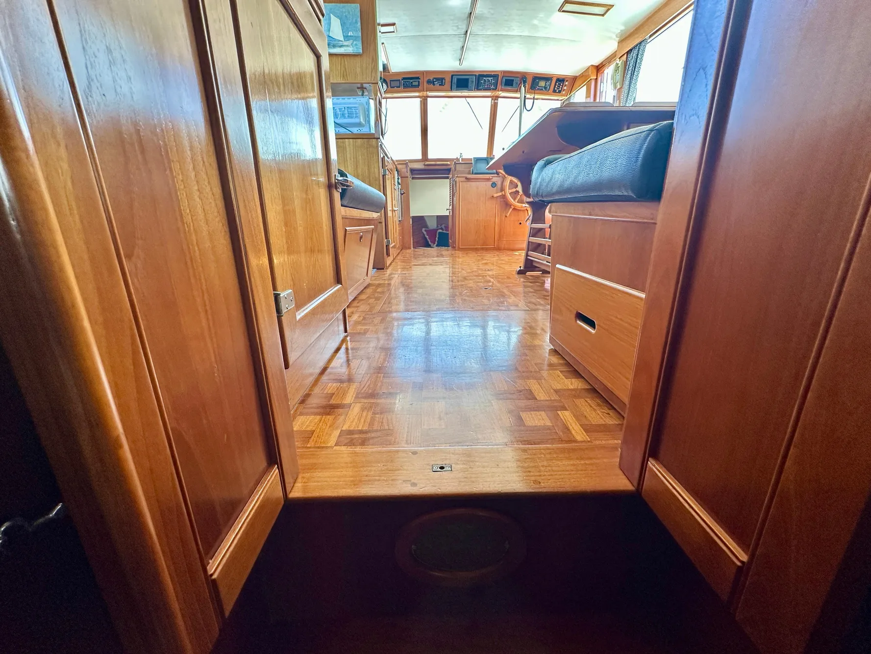 Interior view of 1989 Grand Banks 42 Classic yacht with wooden flooring and seating.