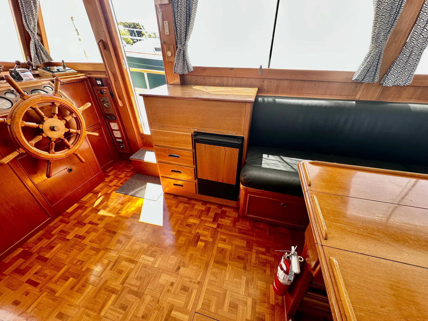 Interior of 1989 Grand Banks 42 Classic yacht with wooden helm and seating area.