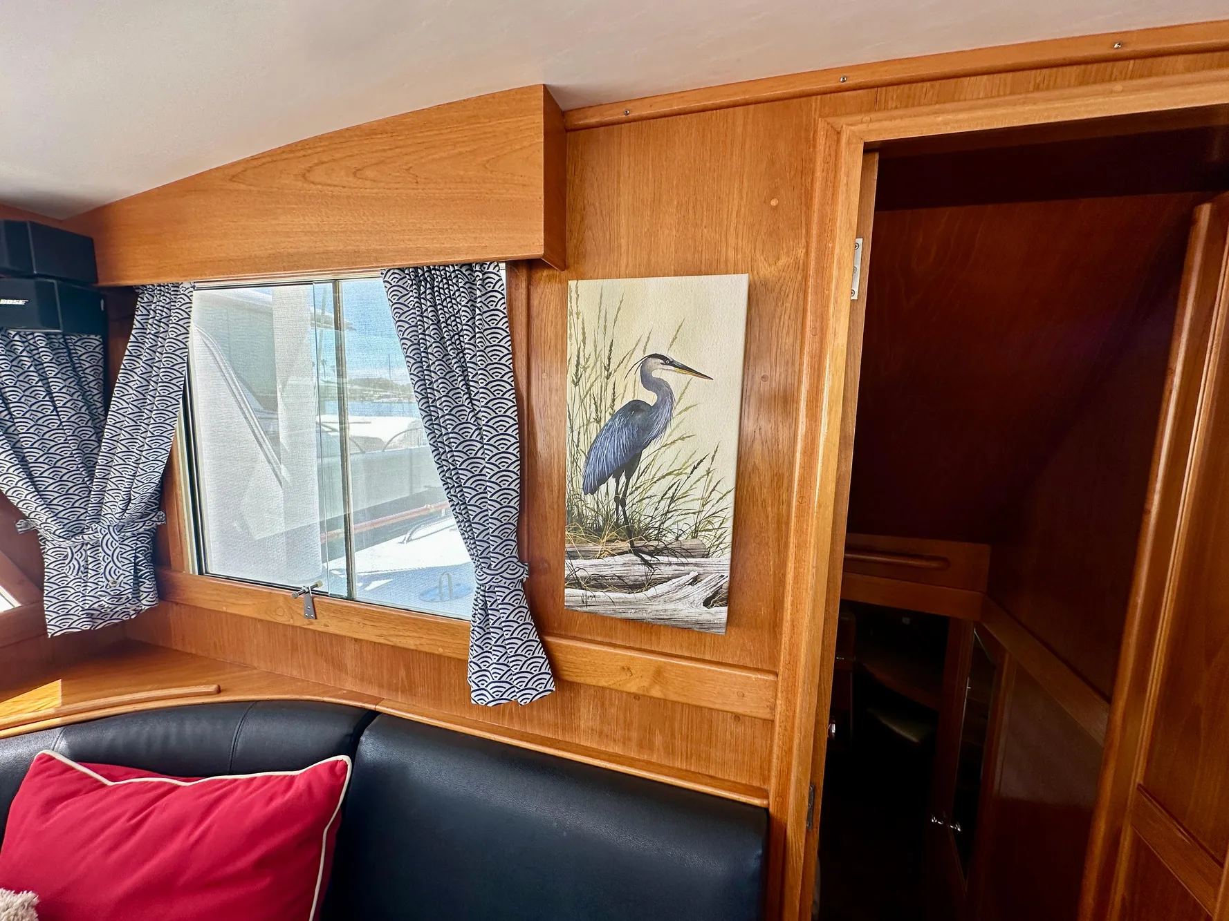 Interior of 1989 Grand Banks 42 Classic with heron painting and patterned curtains.