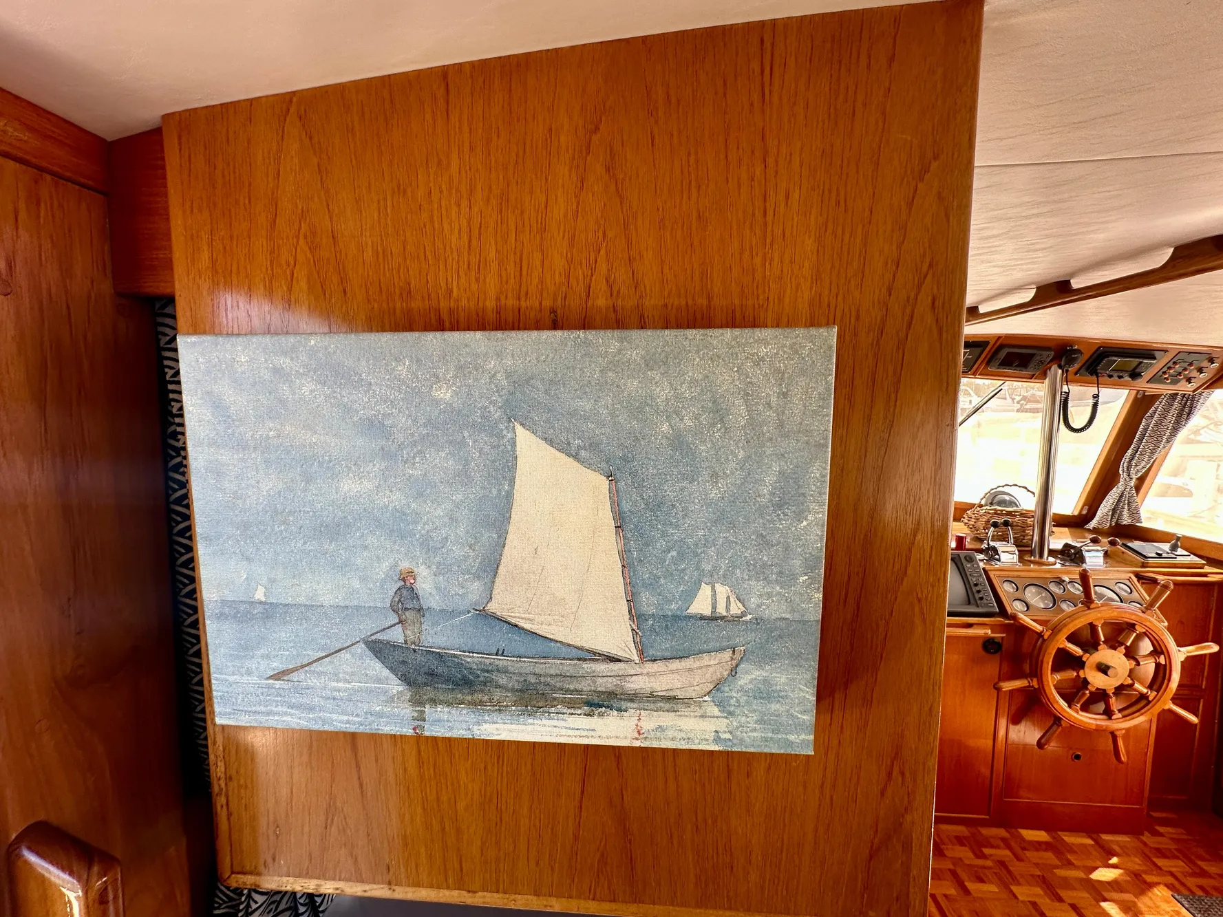 Painting of a sailboat on a wooden wall inside a 1989 Grand Banks 42 Classic yacht.