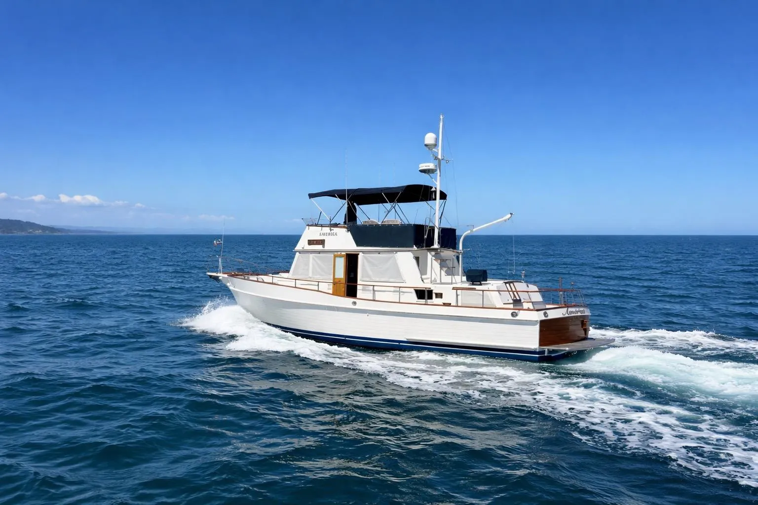 1989 Grand Banks 42 Classic yacht cruising on open sea under clear blue sky.