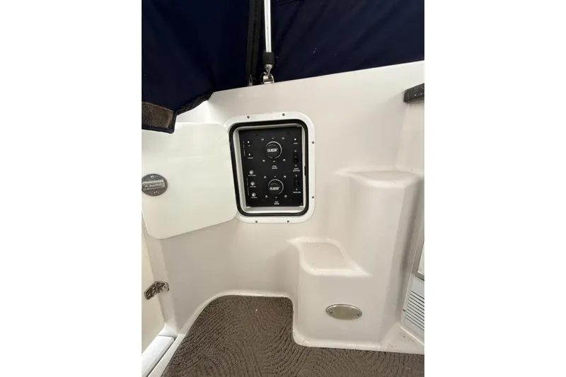  Yacht Photos Pics Control panel on 2007 Four Winns 378 Vista boat interior, featuring steps and carpeted floor.