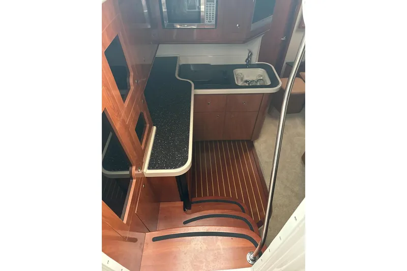  Yacht Photos Pics 2007 Four Winns 378 Vista yacht interior with kitchenette, wood flooring, and modern amenities.