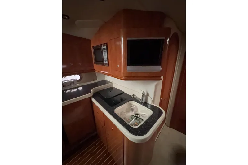  Yacht Photos Pics 2007 Four Winns 378 Vista yacht interior kitchen with sink, microwave, and TV.
