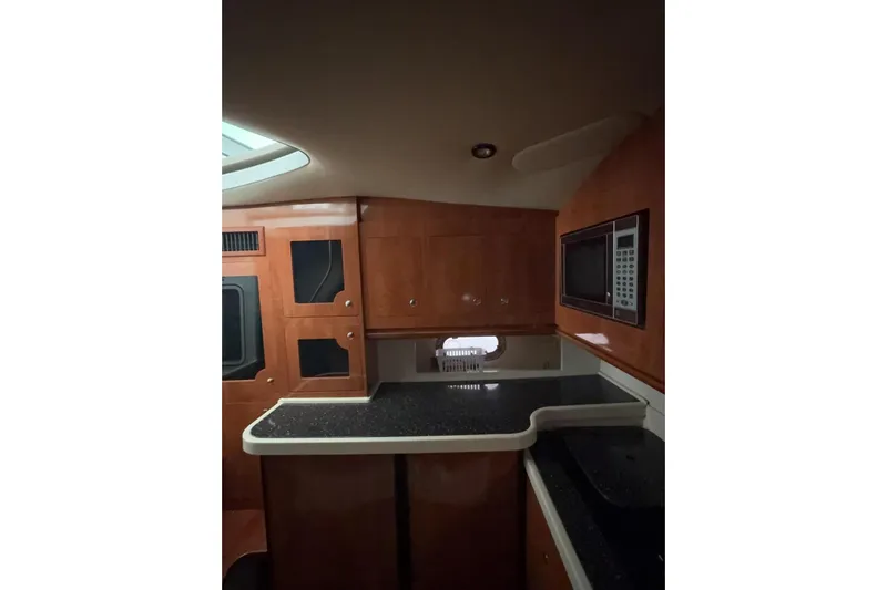  Yacht Photos Pics 2007 Four Winns 378 Vista yacht interior with wood cabinetry and modern appliances.