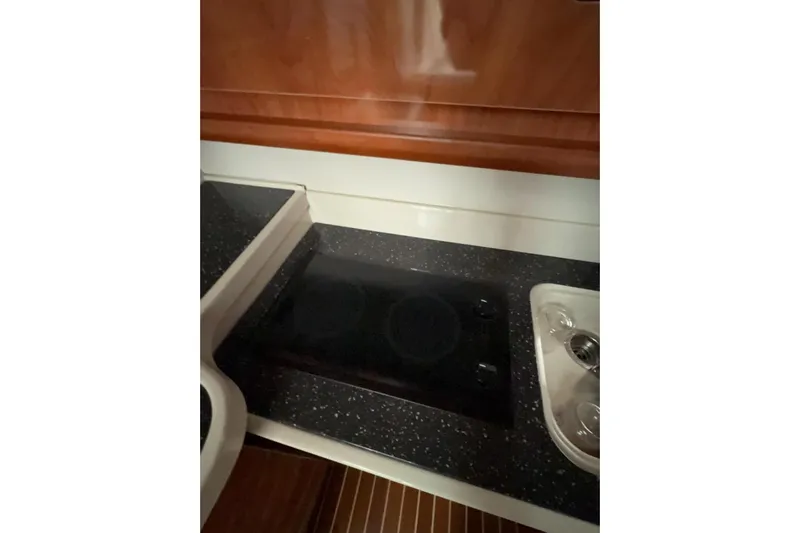  Yacht Photos Pics 2007 Four Winns 378 Vista yacht kitchen with black countertop and stove.