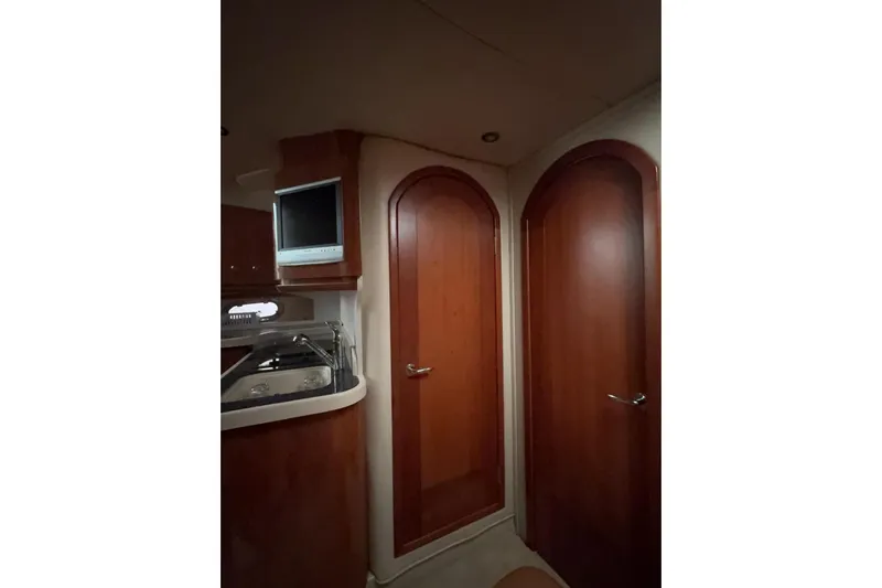  Yacht Photos Pics Interior of 2007 Four Winns 378 Vista yacht with wooden doors and compact TV.