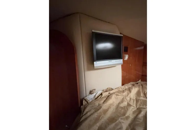  Yacht Photos Pics 2007 Four Winns 378 Vista cabin interior with wall-mounted TV and bedding.