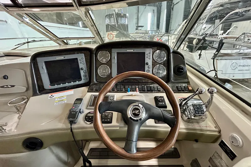  Yacht Photos Pics Helm of 2008 Sea Ray 44 Sundancer with dual screens and wooden steering wheel.