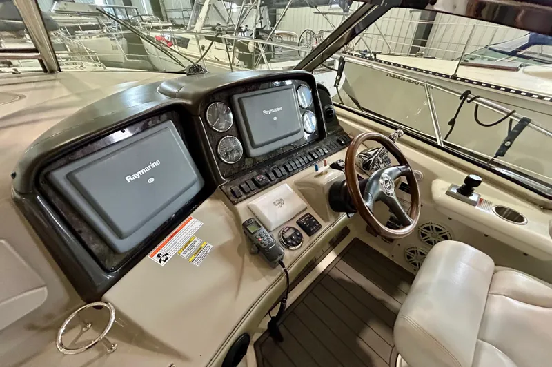  Yacht Photos Pics 2008 Sea Ray 44 Sundancer helm with Raymarine displays and wooden steering wheel.