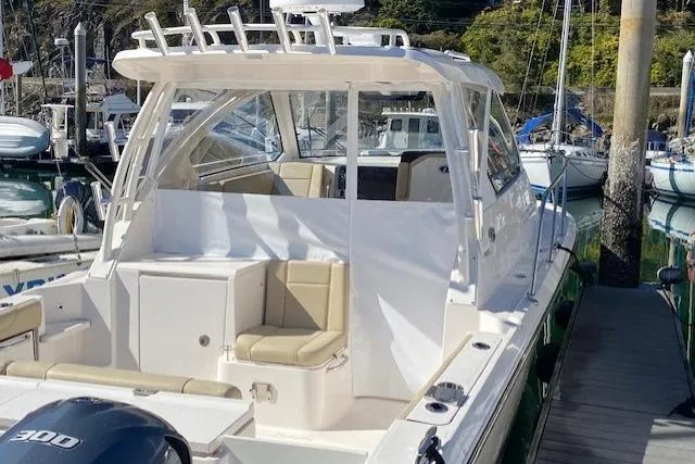 Syd Fishes Yacht Photos Pics 2017 Pursuit OS 325 Offshore boat docked, featuring spacious seating and sleek design.