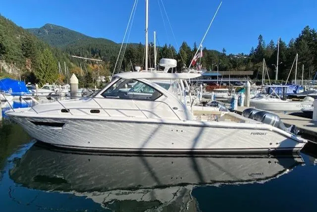 Syd Fishes Yacht Photos Pics 2017 Pursuit OS 325 Offshore boat docked in a scenic marina setting.
