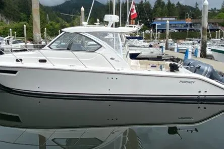 Syd Fishes Yacht Photos Pics 2017 Pursuit OS 325 Offshore boat docked in a marina, reflecting on calm water.
