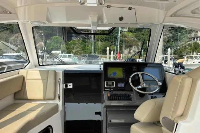 Syd Fishes Yacht Photos Pics Interior of a 2017 Pursuit OS 325 Offshore boat with modern helm and seating.